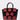 The STAY IN MY BAG PURSE has a structured silhouette in glossy faux leather, with seven small red handbags—each with a handle and gold clasp—arranged in two rows on the front of the large black bag.