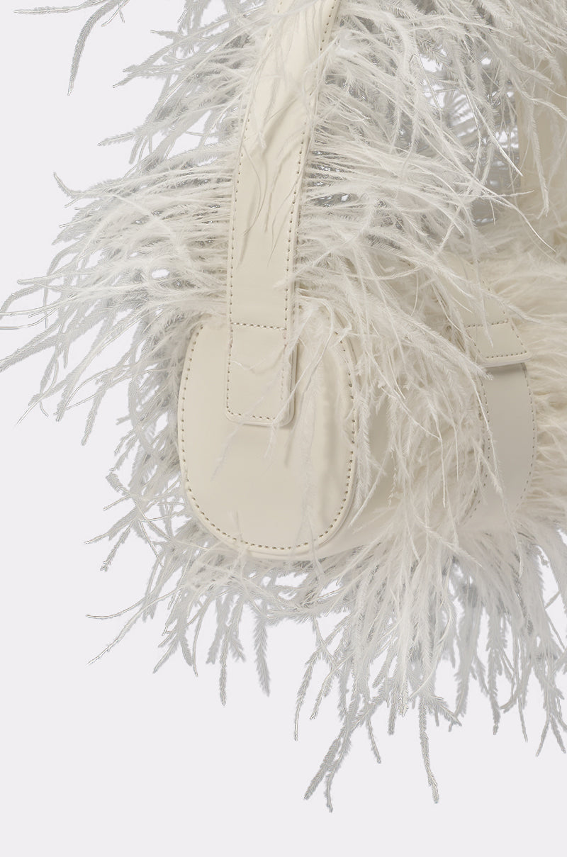 Close-up of the LET ME FLY PURSE—a cream-colored handbag featuring long, feathery fringe and a smooth faux leather handle, perfect as an elegant bridal accessory. 3