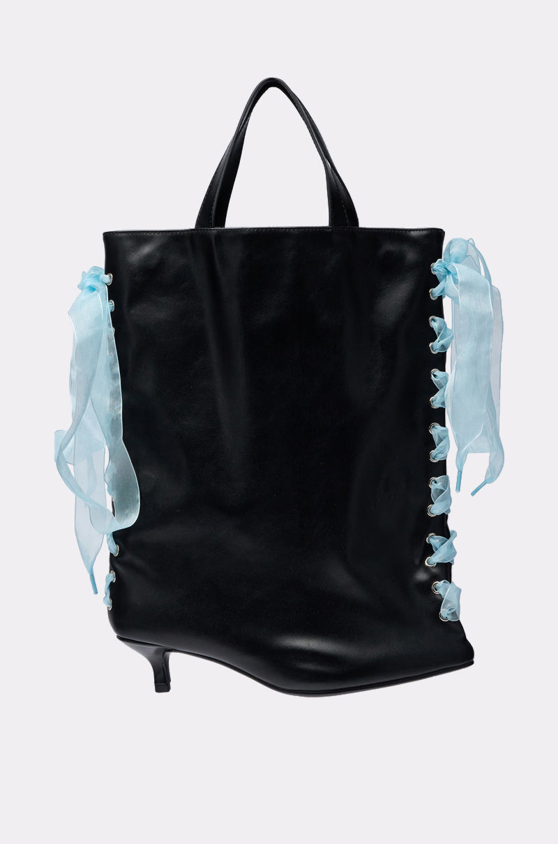 The TIE MY SHOE PURSE is a black vegan leather bag with short handles, blue ribbon laces on the sides, and a small high-heel shoe detail at one corner for a stylish yet functional touch. 4