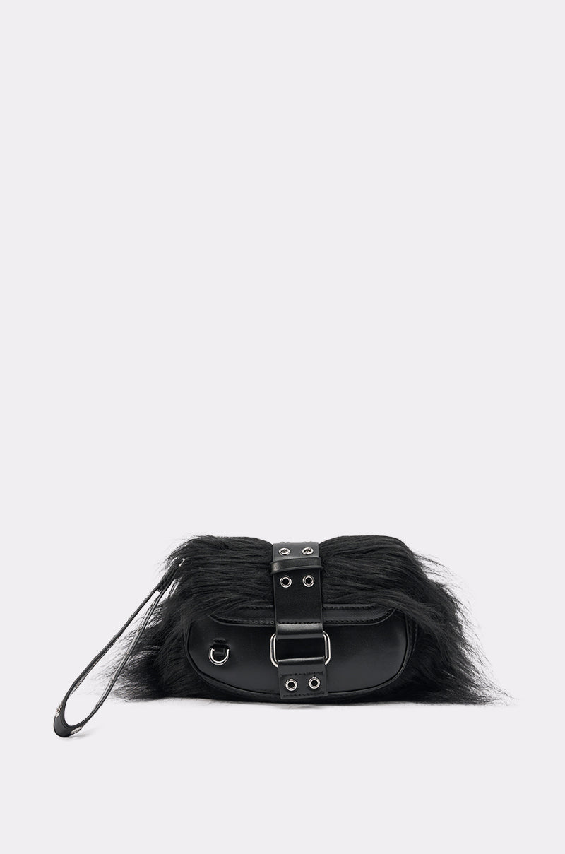 The ON THE TOWN WRISTLET is a small black faux leather handbag featuring a furry top, buckle detail, metal eyelets, and a wrist strap—the ideal chic accessory for your night out, shown against a plain light background. 0