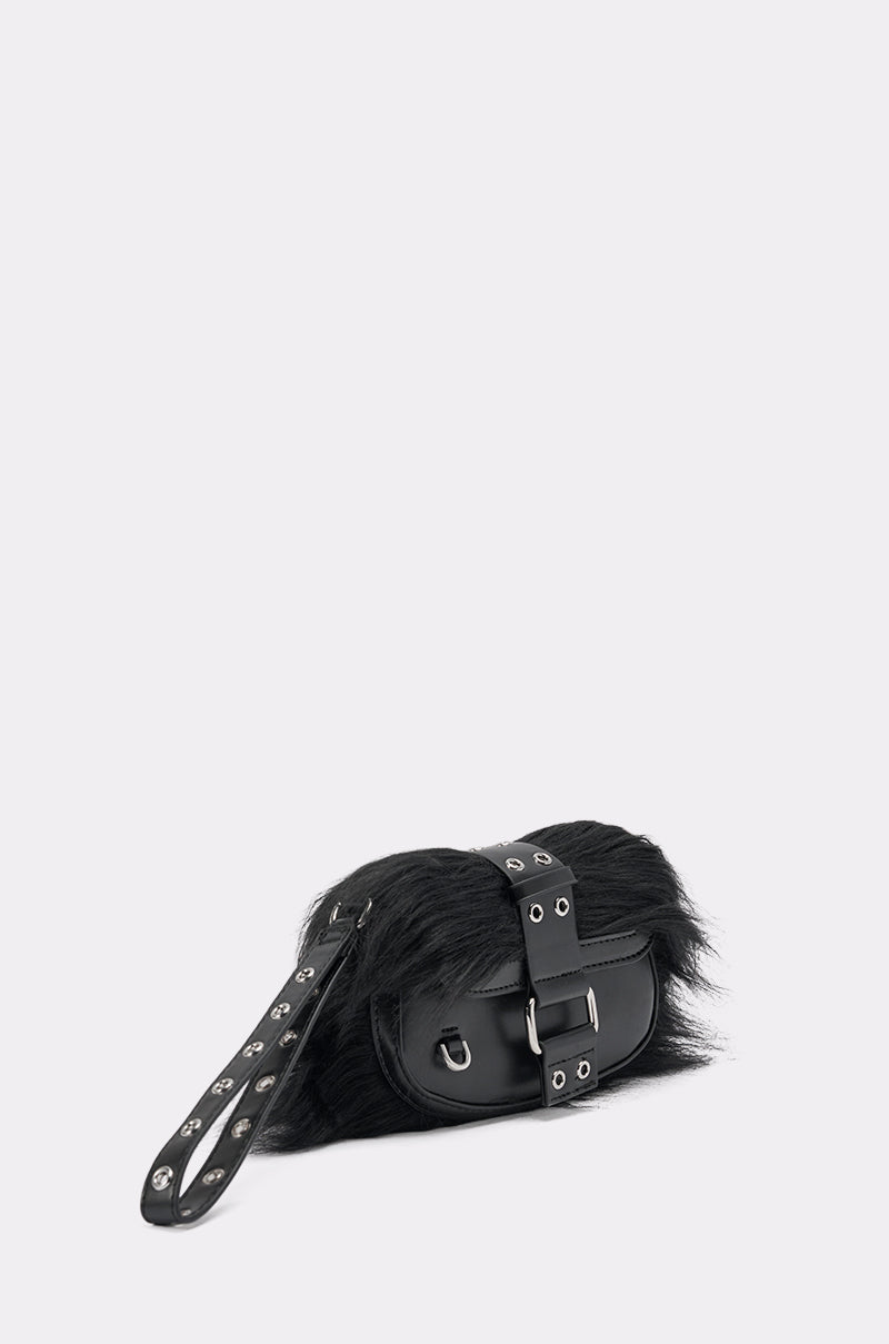 The ON THE TOWN WRISTLET—a small black faux fur handbag with a silver studded strap and buckle—makes the perfect night-out accessory, shown against a plain light gray background. 2