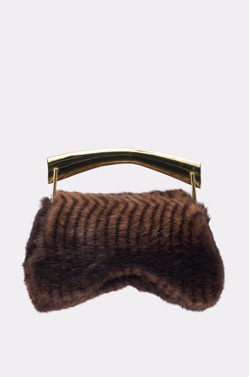 The COCO FAUX FUR BAG is a small brown faux fur bag featuring a metallic gold handle, shown against a plain light gray background. 3