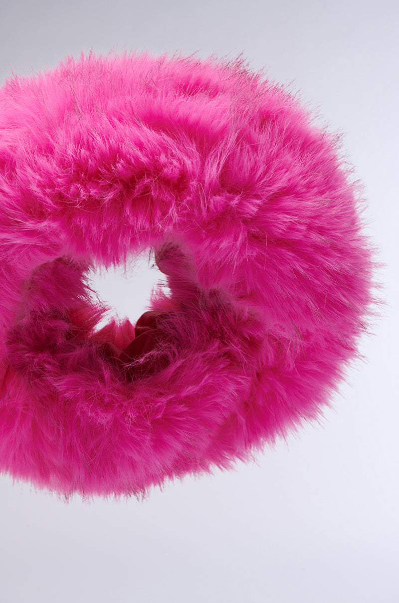 A close-up of the SABRINA FAUX FUR HEADBAND in vibrant hot pink, featuring a loop design against a plain light background. The plush faux fur texture appears soft and fuzzy.