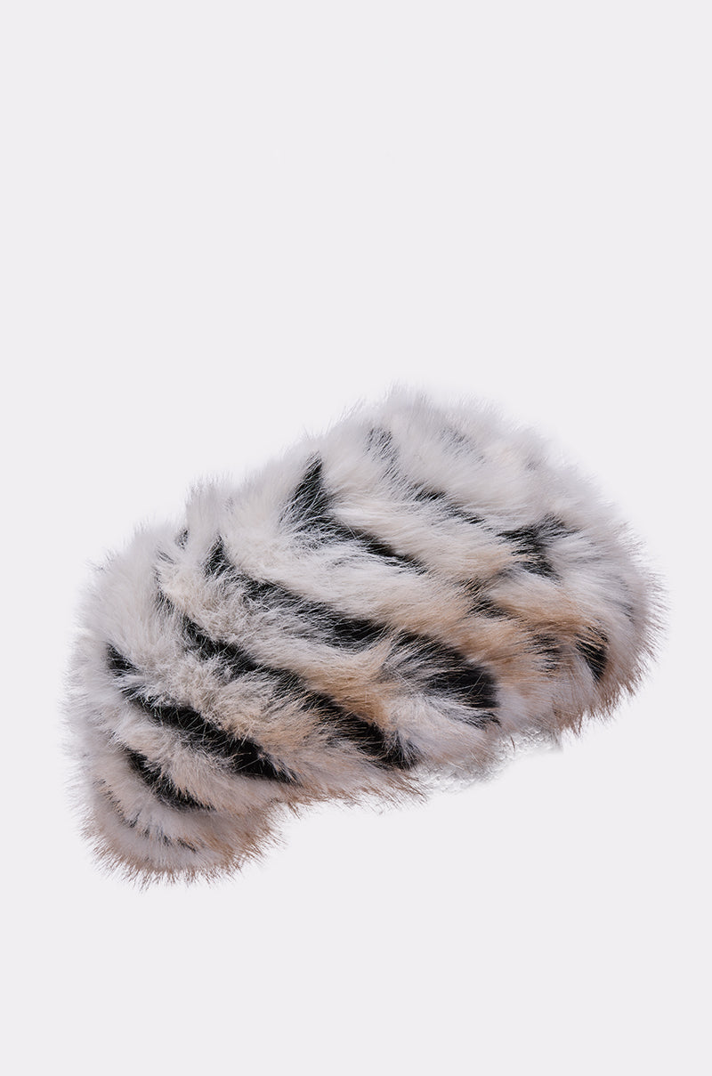 The PORTIA FAUX FUR HEADBAND features a soft, fluffy faux fur texture with white, gray, and black stripes and a smooth satin lining for comfort, shown against a plain light background. 3
