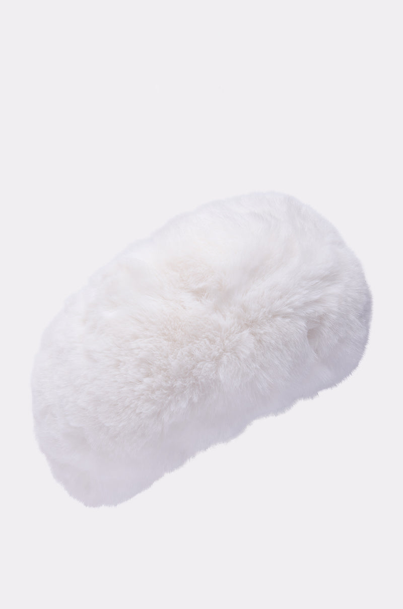 The LUXE JENNY FAUX FUR HEADBAND IN WHITE is shown against a plain light background, highlighting its soft, plush, and dense furry texture—ideal for staying cozy as a stylish headband or winter ear cover.