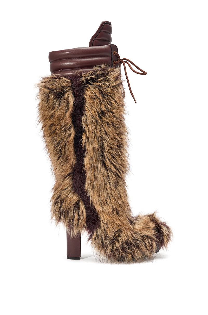 The AZALEA WANG HEARTBEAT BROWN MULTI BLOCK FUR BOOT is a faux fur knee-high with a brown leather upper, chunky block heel, lace-up design, and an exaggerated toe and heel for standout winter style. 2