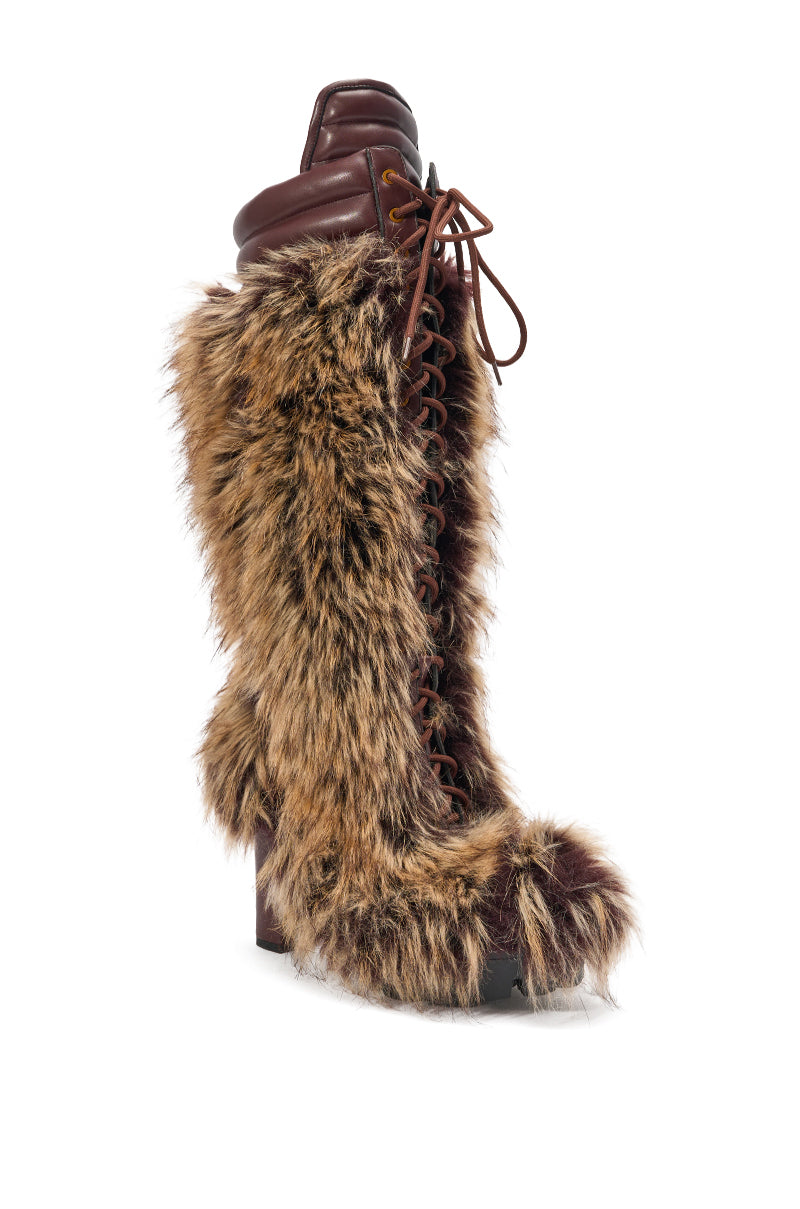 The AZALEA WANG HEARTBEAT BROWN MULTI BLOCK FUR BOOT is a faux fur knee-high boot with a lace-up front, leather accents, and a chunky block heel, blending warmth and style for standout winter wear. 3