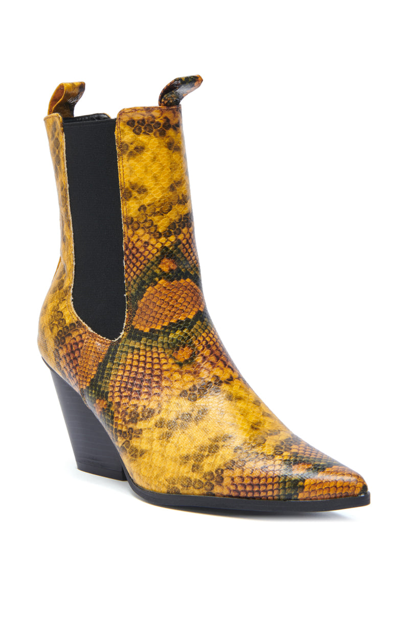 The AZALEA WANG HENDERSON YELLOW CHUNKY BOOTIE features a high heel, pointed toe, yellow and brown snakeskin pattern, black elastic side panels, and front and back pull tabs.