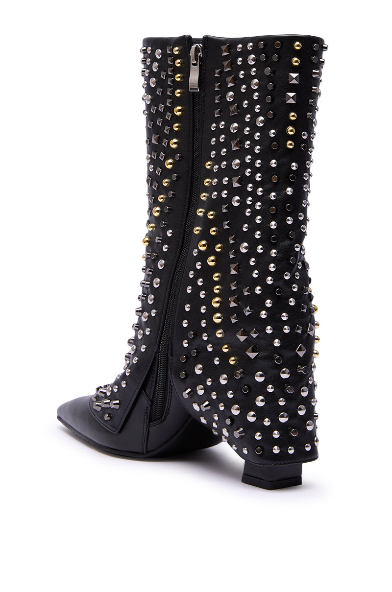 The AZALEA WANG HENZI BLACK HARDWARE EMBELLISHED CHUNKY FOLD OVER BOOTIE features black faux leather, side zippers, silver and gold studs and spikes, a pointed toe, and a low block heel for an edgy look.