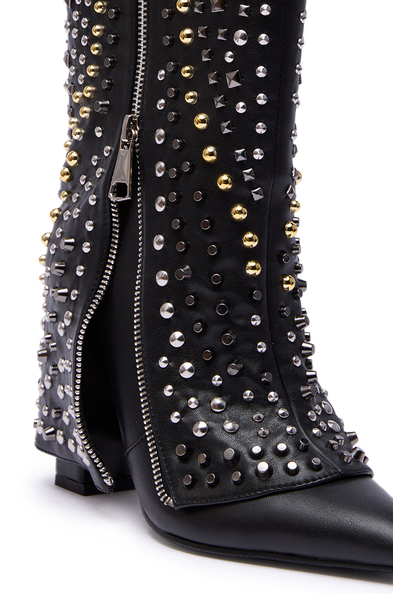 Close-up of the AZALEA WANG HENZI Black Hardware Embellished Chunky Fold Over Bootie, featuring a faux leather design, side zipper, and an array of silver, gold, and black hardware studs in various shapes and sizes.