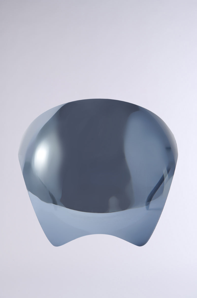A PROTECT YA SELF FACE SHIELD with a modern, glossy, dark gray visor hangs against a light gray background. The mirrored visor has a sleek, curved design with reflective surfaces like oversized sunglasses. 0