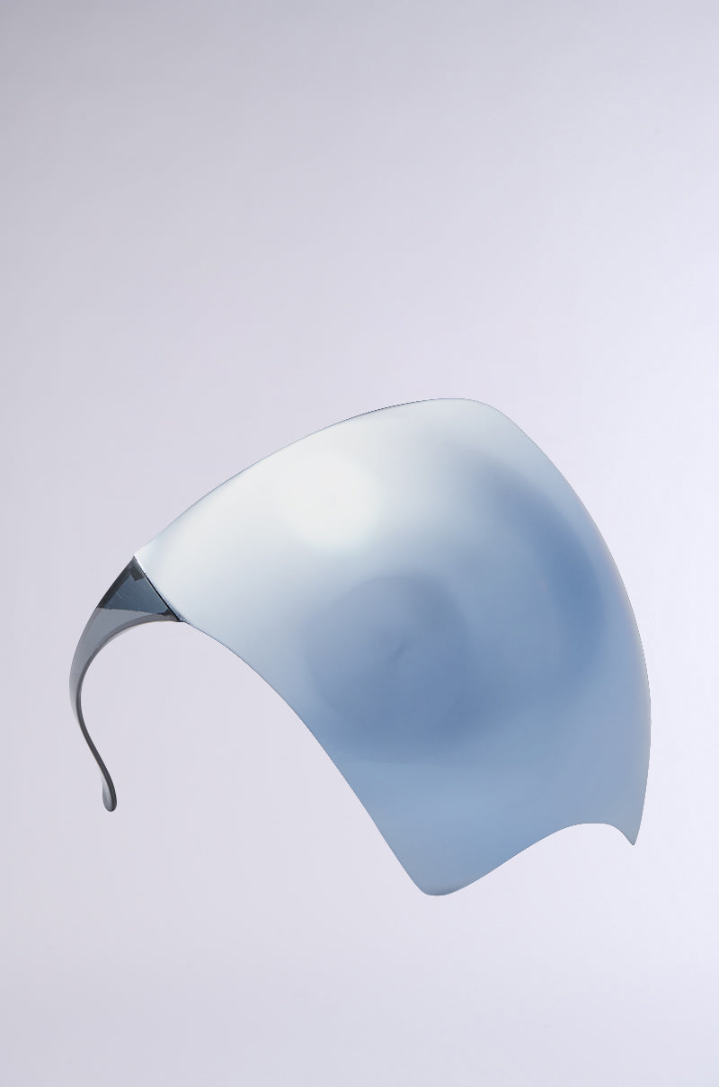 The PROTECT YA SELF FACE SHIELD, featuring a futuristic curved design, sleek blue-tinted mirrored visor, is photographed against a plain white background. 3