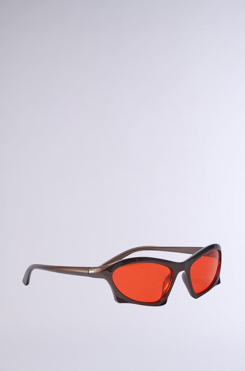 SEEING RED SUNGLASSES showcase an angular design with a sleek brown plastic frame and vibrant red-tinted lenses, elegantly displayed on a plain gray background. 3