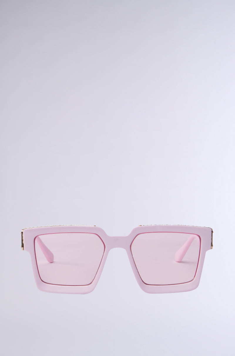 The TOO DESIGNER SUNGLASSES feature pink square frames with rose-tinted lenses, set against a plain background. The frames sport a sleek design and thin profile.