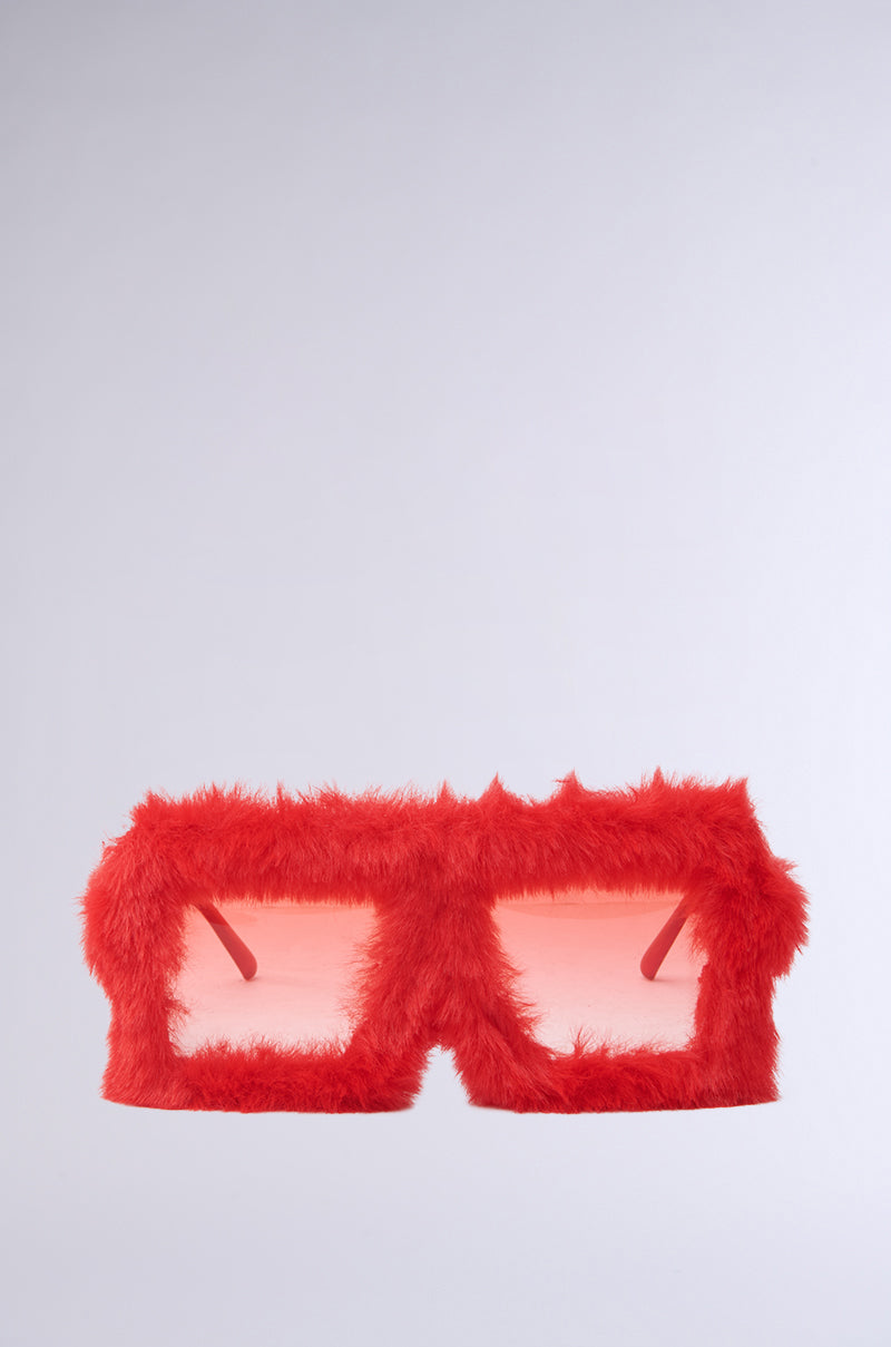 These I'M PAST THIS FUZZY SUNGLASSES feature a quirky oversized monobrow silhouette with red, fur-covered square frames and playful pink-tinted lenses.