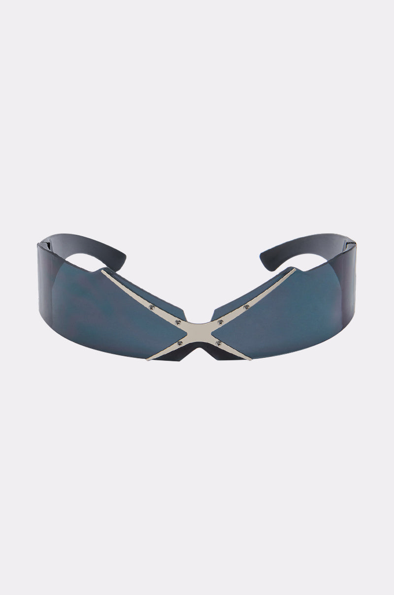 SEE THRU U SUNGLASSES feature a futuristic shield design with a single blue-tinted visor lens and a metallic X-shaped nose bridge, showcased on a plain light gray background.