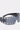 The HERE FOR THE VIBES SUNGLASSES feature a black futuristic wraparound frame, a single curved tinted visor lens, and silver grommets along the top and bottom edges for a bold, fashion-forward look.