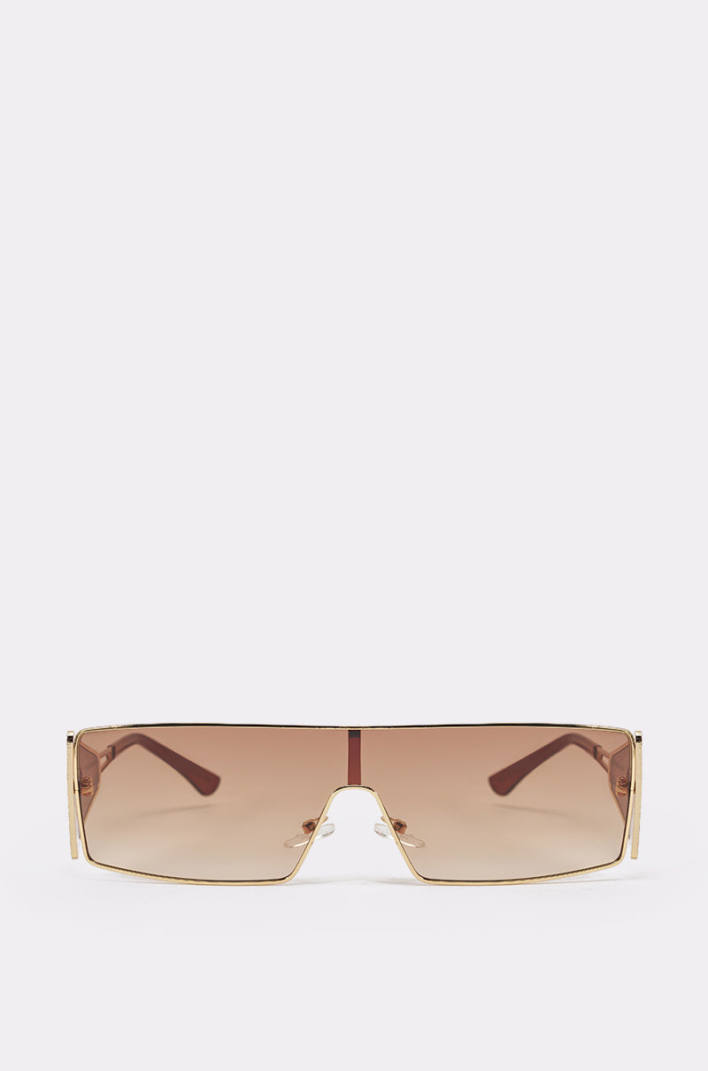 VIXEN SUNGLASSES: Retro shield style with a rectangular, rimless silhouette, single gradient brown lens, and gold-tone metal arms. Displayed on a plain light background. 2