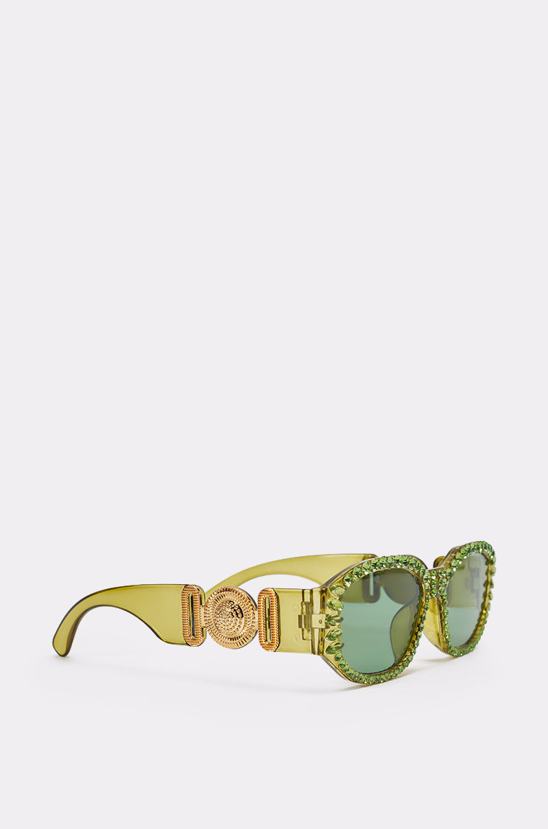CATCH MY VIBE SUNGLASSES feature transparent green frames, gold ornate arm detailing, and green rhinestones outlining the lenses—bold statement eyewear displayed on a plain white background. 3