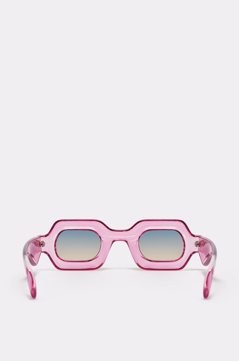JELLY SUNGLASSES: Pink, geometric rectangular sunglasses with a chunky frame and blue gradient lenses, displayed on a plain light background facing forward. 2