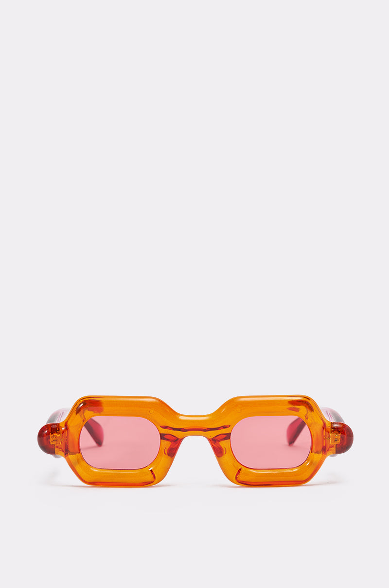 SORBET SUNGLASSES in bright orange feature chunky rectangular frames and pink tinted lenses, displayed on a plain white background to highlight their bold style and unique look. 0