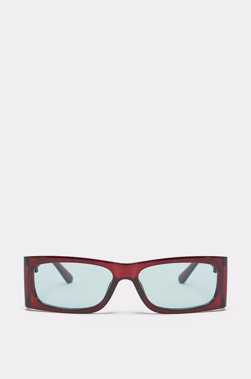 KEKE SUNGLASSES feature a glossy dark red geometric rectangular frame and light blue-tinted lenses, shown from the front against a plain light background. 0