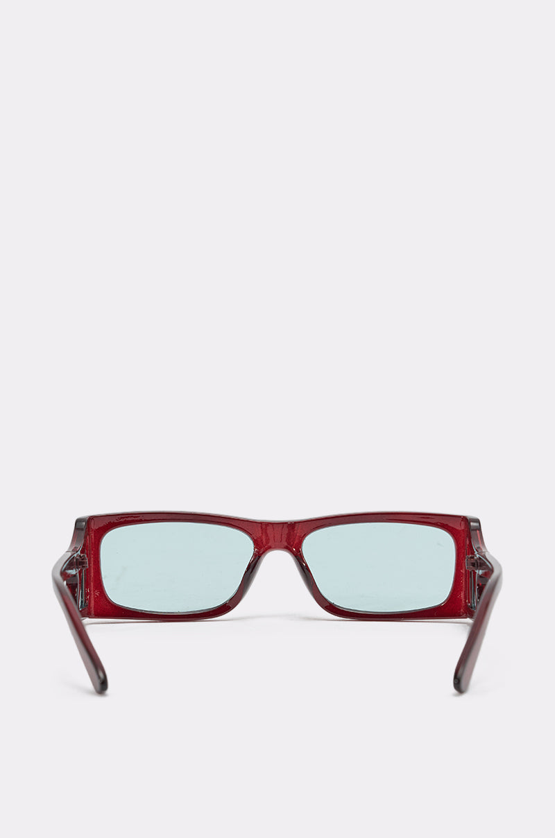 The KEKE SUNGLASSES are rectangular, red geometric frame sunglasses with light blue tinted lenses, shown facing forward on a plain white background. 3