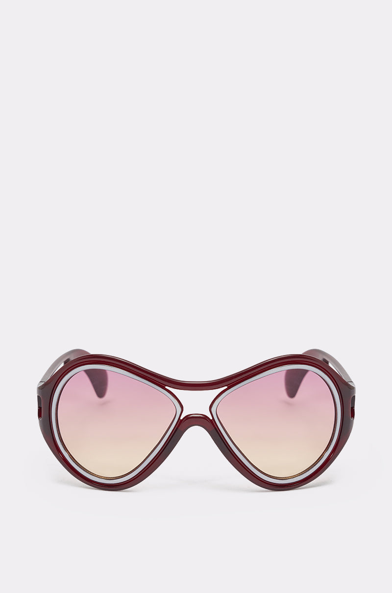 WILLY SUNGLASSES: Oversized retro shades featuring maroon frames and large gradient pink-to-beige lenses, showcased against a simple light background. 2