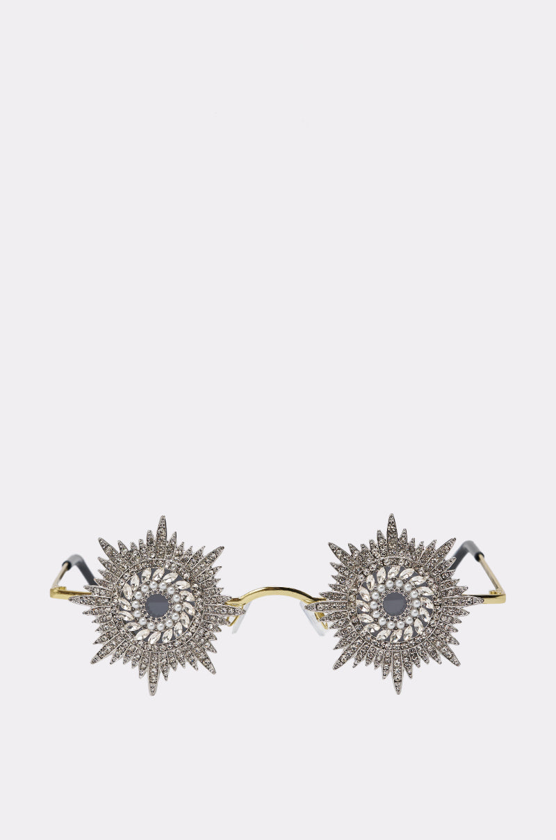 WHY DO I NEED TO SEE SUNGLASSES feature gold frames and ornate silver starburst decorations adorned with rhinestones over the lenses. 0