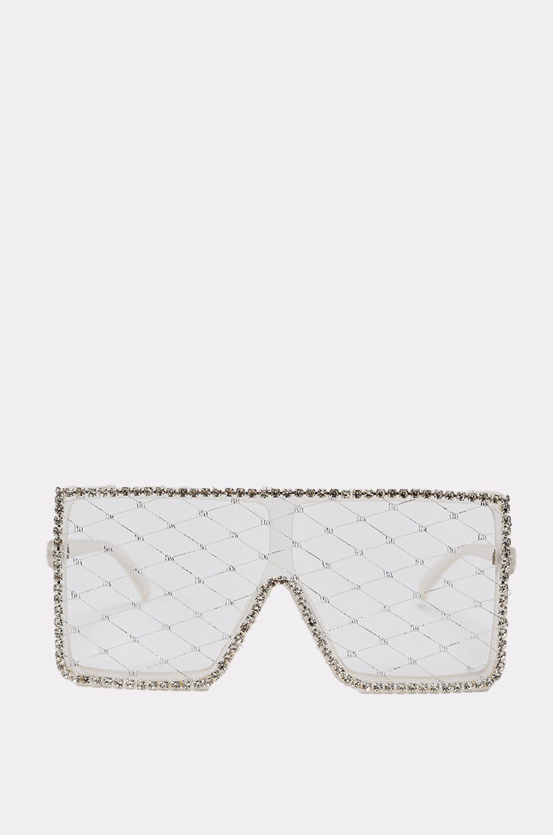 BEEZ SUNGLASSES feature a transparent oversized visor-style shield with silver rhinestone trim. Clear lenses display a subtle diamond pattern and small text, creating a modern, eye-catching fashion statement. 0