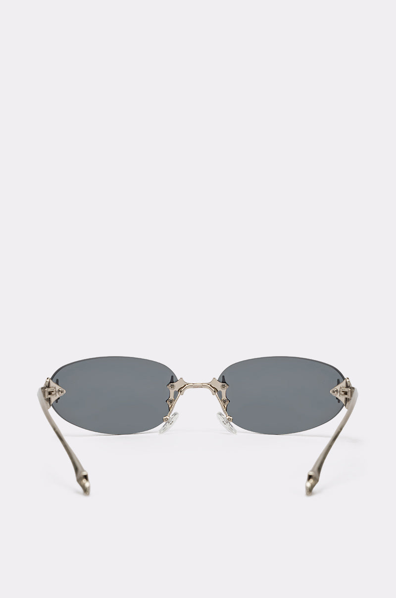 CYBER SUNGLASSES feature oval dark lenses, silver metal frames, and curved arms for a classic Y2K vibe, shown facing forward on a plain white background. 4