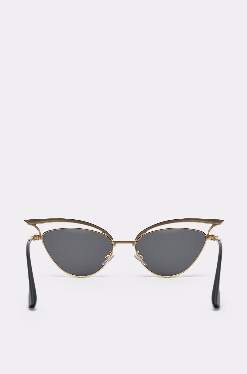 The AUDREY SUNGLASSES feature gold-accented cat-eye frames, dark lenses, and sleek black arms, shown against a plain white background. 3