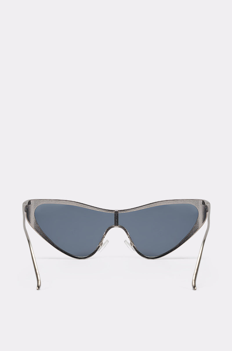 TO THE FUTURE SUNGLASSES showcase a silver-tone metal frame with a bold angular cat-eye shape and dark tinted lenses, presented on a plain white background. 2