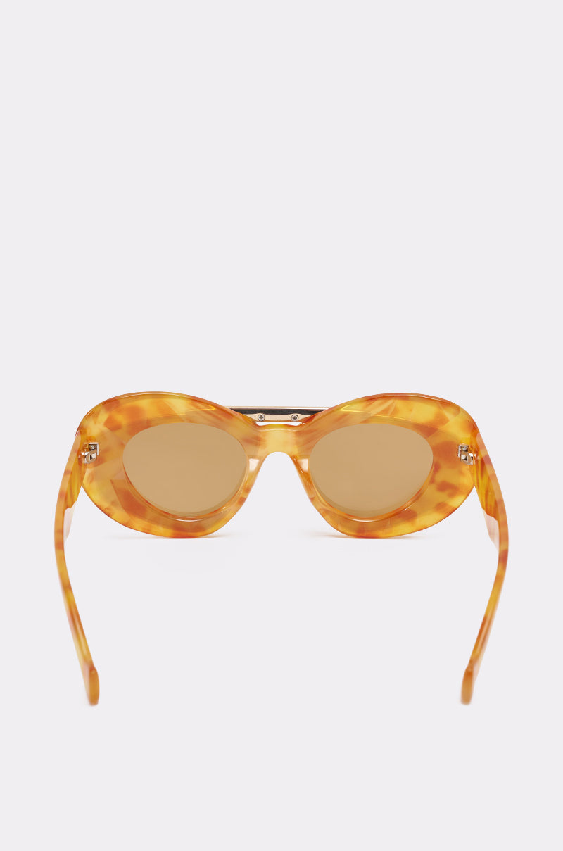 Front view of QUITE LUX SUNGLASSES with amber tortoiseshell frames and light brown tinted lenses, displayed against a plain light background. 2