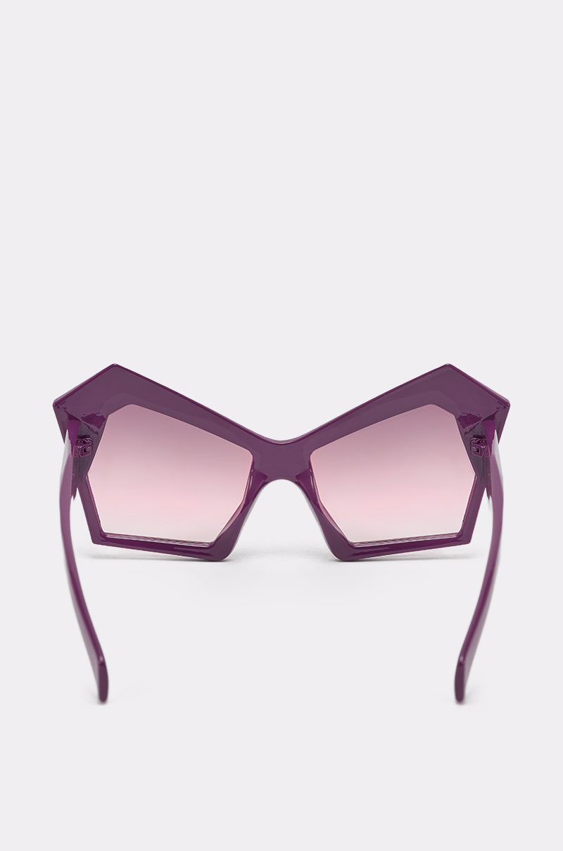 ON TREND SUNGLASSES feature oversized purple pentagon-shaped frames with pink gradient lenses, shown front-facing on a plain white background—ideal statement shades for a bold, geometric look. 3