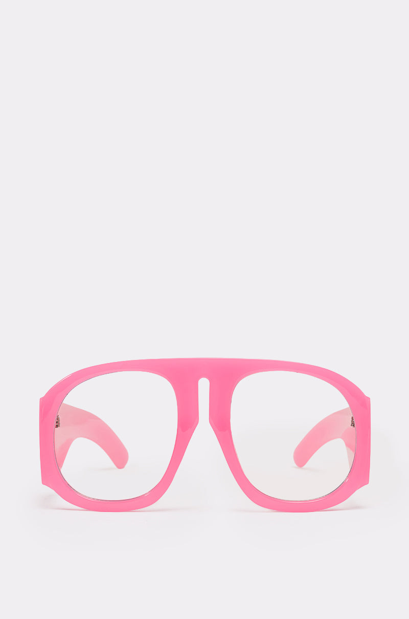 The SEE U L8R GLASSES feature bold, thick pink plastic wrap frames with large rounded rectangular lenses and a modern, playful Y2K-inspired design, showcased on a plain white background.