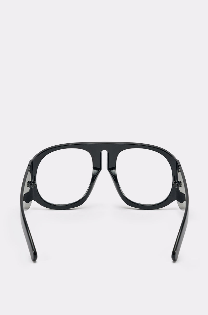 READ ME GLASSES: Black bold-frame eyeglasses with clear lenses, displayed from the back with arms open against a plain light background. 3