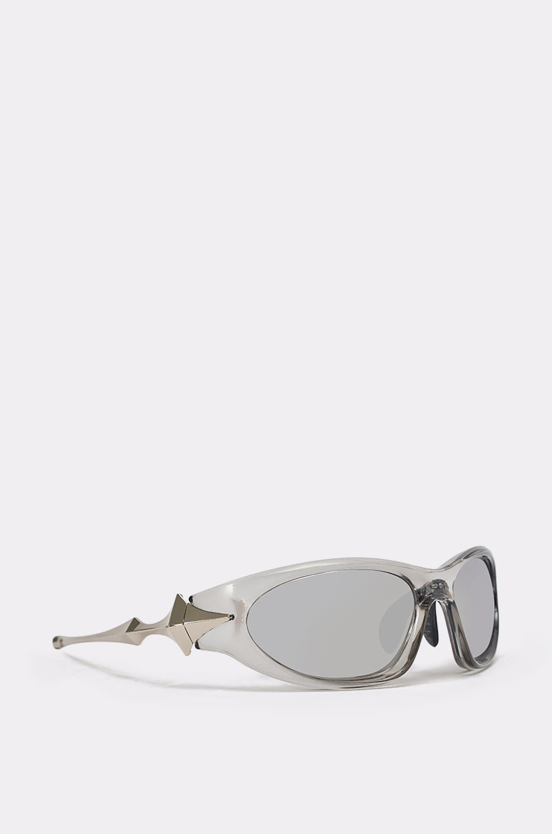 STARSTRUCK SUNGLASSES: Futuristic, oval wrap shades with silver frames, mirrored lenses, and bold pointed metallic accents extending from the temples. 3