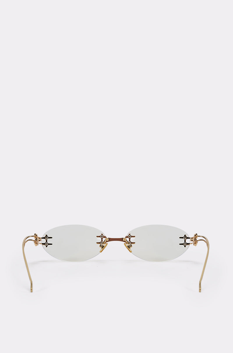 TREND DRIVEN GLASSES feature a minimalist design with rimless oval lenses, a gold-tone metal frame, slender gold temples, and a gold bridge, showcased against a plain white background. 4