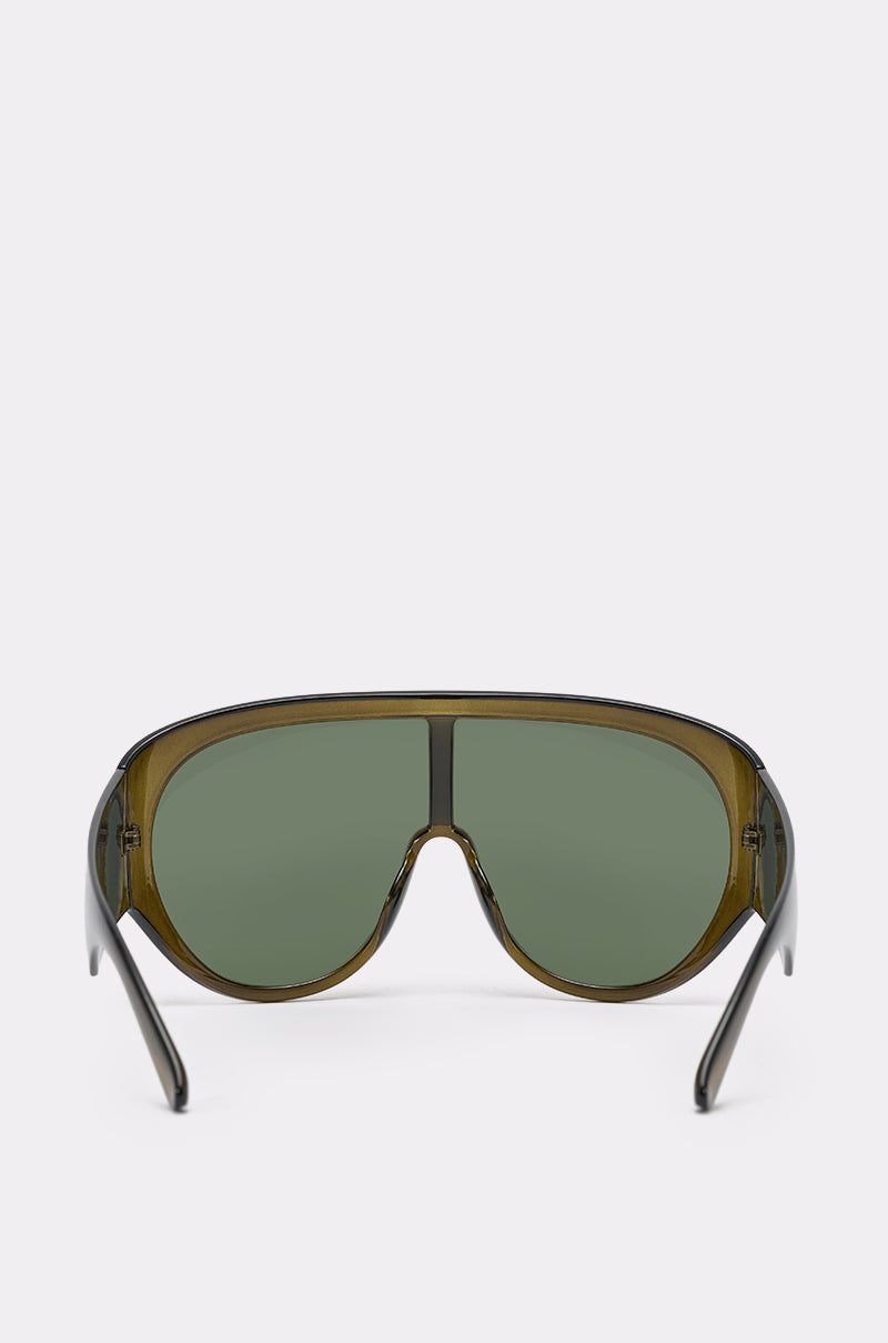 Front view of TOMBOY SUNGLASSES featuring oversized shield design, green-tinted lenses, and thick translucent olive-green frame—ideal for bold streetwear style, displayed on a plain white background. 4