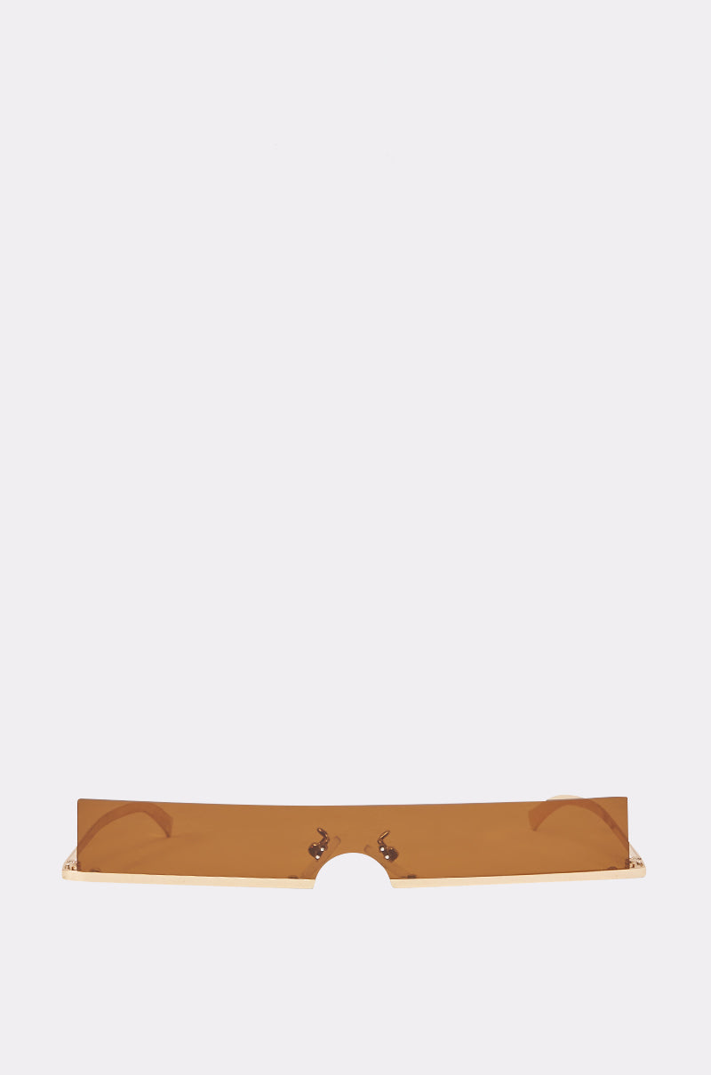 The SLIM VISOR SUNGLASSES feature a rectangular shape with a brown-tinted, flat, and wide lens design that has no visible frame—ideal for trendy summer styling. Displayed against a plain light gray background.