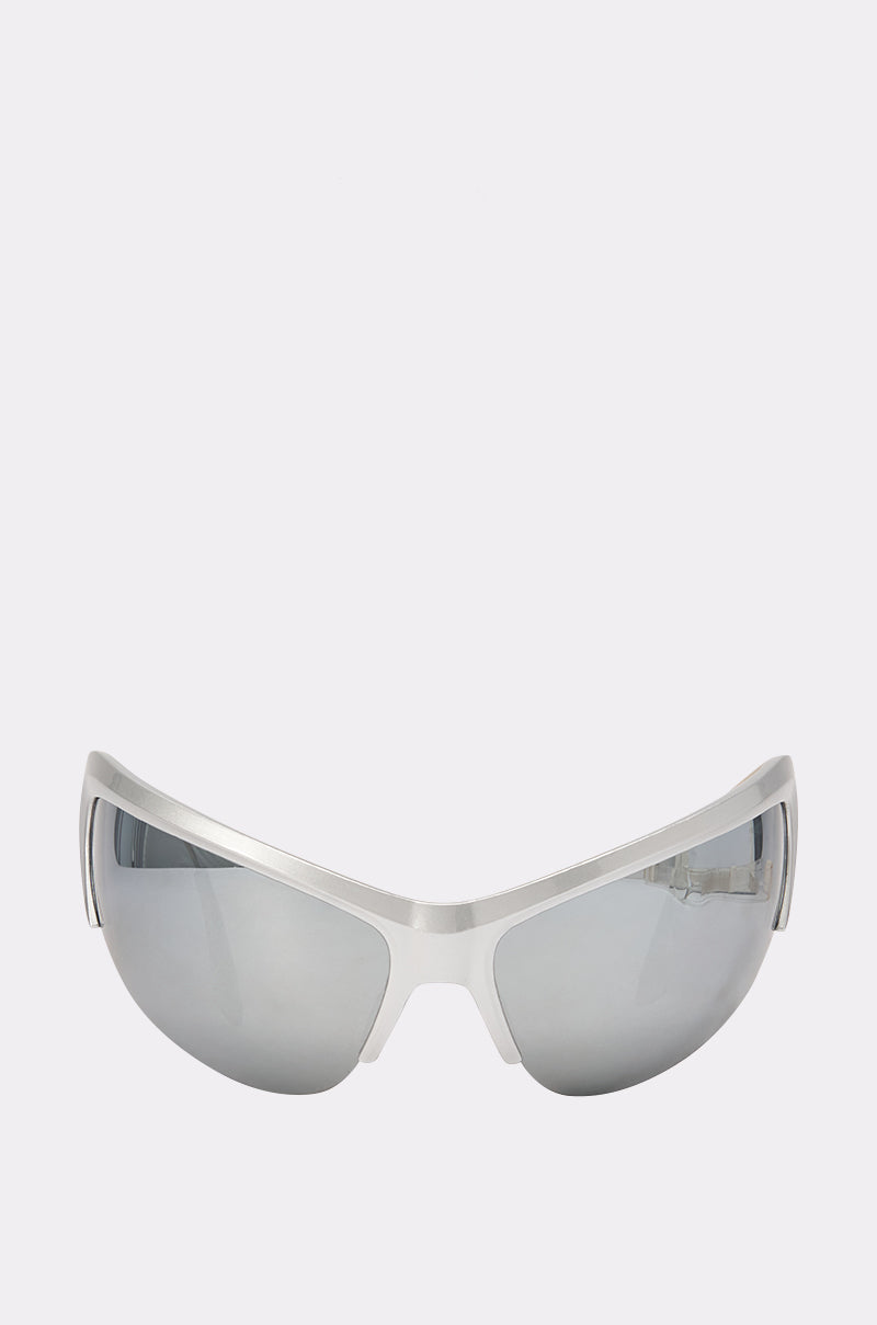 The FAST LANE SUNGLASSES feature a sleek, silver frame and wrap-around mirrored lenses, perfect as festival sunglasses, shown against a plain white background.