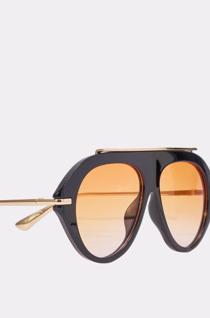 Close-up of LUXE AIR SUNGLASSES IN BLACK ORANGE, featuring oversized aviator frames in black and orange with gold arms and upper bar, plus large rounded orange-tinted lenses. The perfect choice for standout summer style. 4