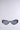 Introducing VENOM LOVE SUNGLASSES: fashion-forward black cat-eye frames with metallic snake-inspired side detailing. Featuring dark oval lenses, these bold sunglasses stand out effortlessly against a light gray background.