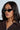 A person with long dark hair wears VENOM LOVE sunglasses and a ribbed dark zippered top. They face slightly to the side, against a light backdrop, exuding understated elegance with their calm expression.