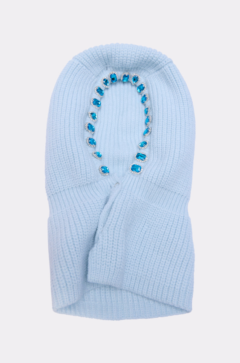 The TRU EMBELLISHED SNOOD is a light blue fisherman knit hood balaclava with an oval face opening, trimmed with blue and clear rhinestone jewels around the edge, shown on a plain white background. 5