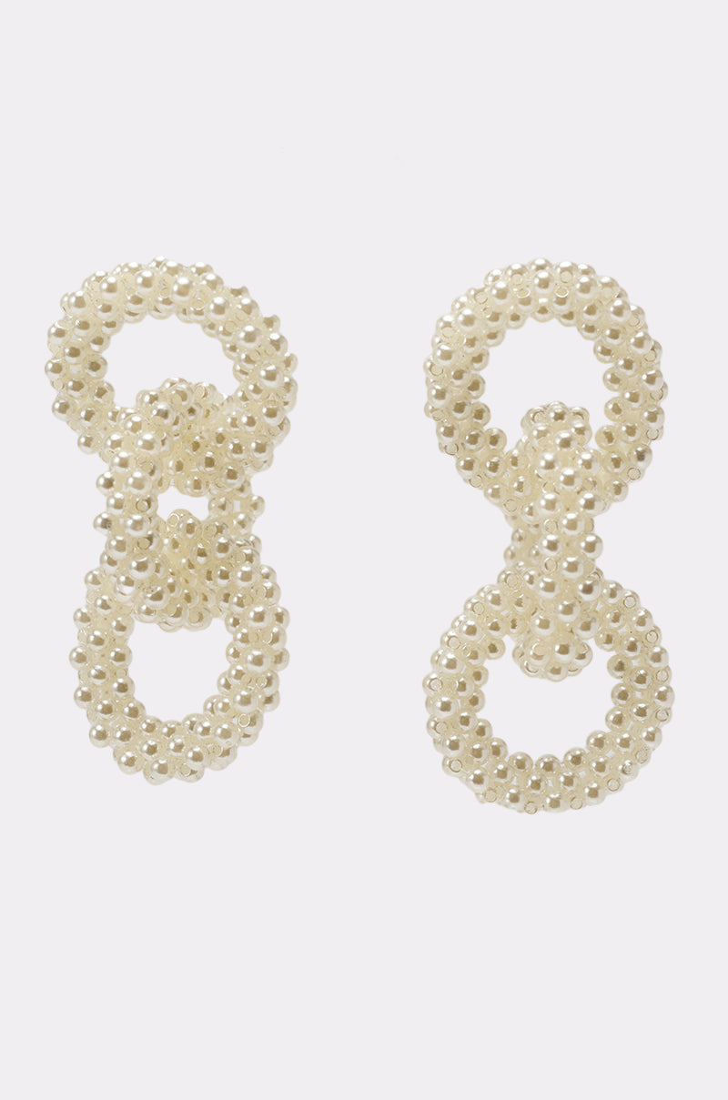 The PEARL BABY DANGLE EARRING features three interlocking loops of small, white pearl-like beads in each earring, displayed vertically against a plain white background. 1
