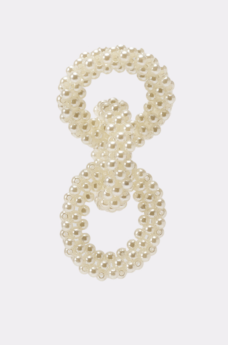 The PEARL BABY DANGLE EARRING features two interlocking loops of shiny ivory beads in a textured design, creating an elegant accessory—ideal as statement pearl bead earrings on a plain white background. 3