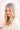 A woman with long blonde hair wears the PEARL DREAMS BEADED HAT, its fringe cascading gracefully. Her striking red eye makeup complements her white outfit. The background showcases a soft, blurred circular light that creates a dreamy pearlescent colorway effect.