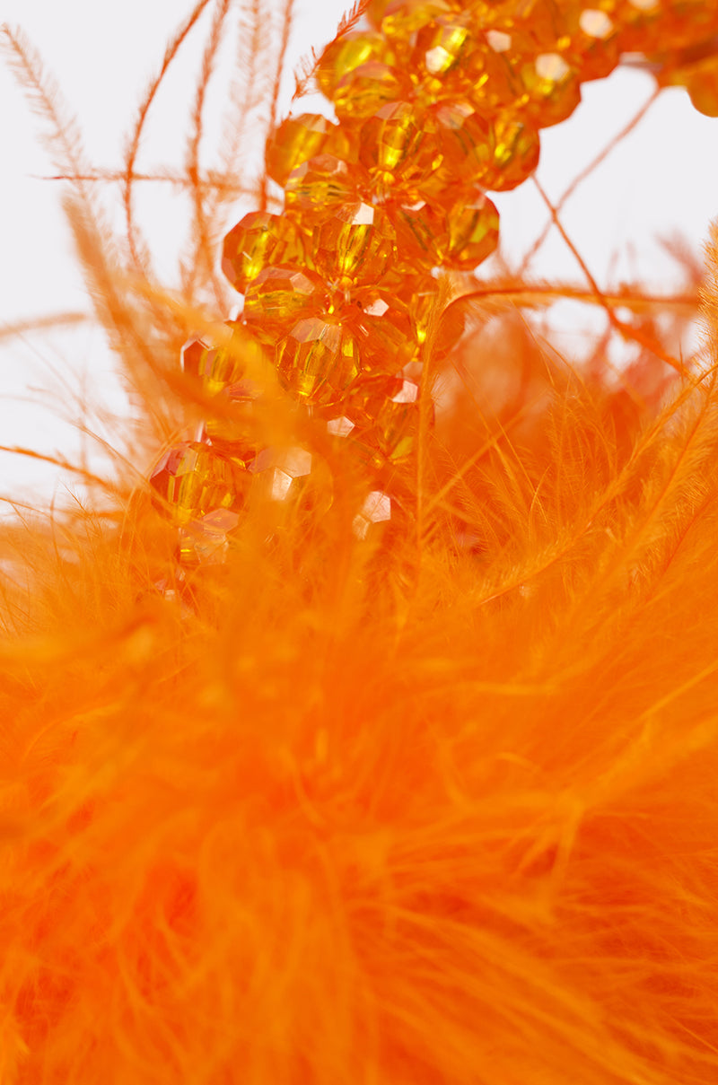 Close-up of the NIGHT OUT BEADED FEATHER BAG, featuring vibrant orange beads and fluffy feathers for a lively, textured look. 4